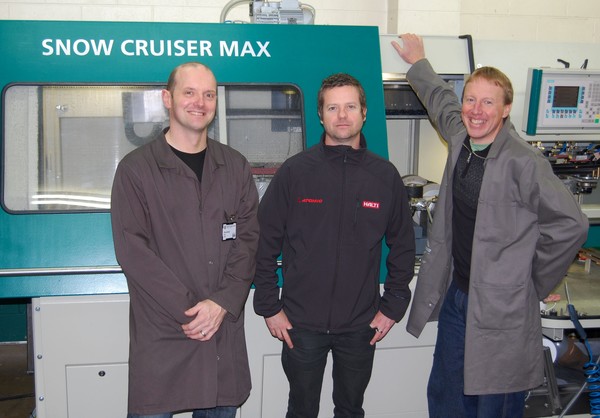 Browns directors Paul 'Haggis' Vaitkus (L) and Kris Vermeir (R) with importer Ian Bright from importer Brandex in Christchurch (centre) and the new Montana Snow Cruiser Max at the company's ski shop in Queenstown